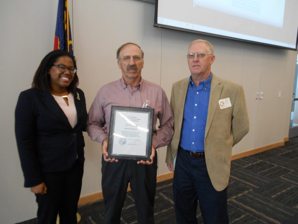 Ben Knox, President of the North Carolina Soil and Water Districts, and Danielle Adams, Area IV Chair of Durham, presented Granville County District Supervisor Ronnie Burnette (center), with his 20 year plaque. The presentation was made at the November 2016 Area Meeting in Durham. Burnette serves as Chairman of the Granville Soil and Water Board. 