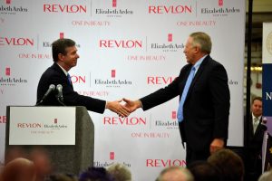 Governor Roy Cooper gives NC flag to Revlon