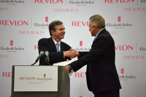 Governor Roy Cooper gives NC flag to Revlon